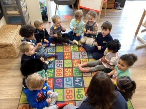 children sat in a circle at nursery in wilmslow